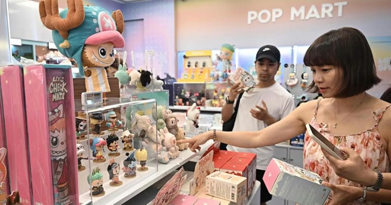 Shoppers browsing collectible designer toys at a Pop Mart store, selecting figurines and blind boxes