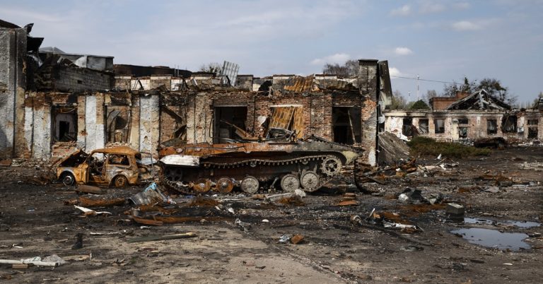 Destroyed buildings and burnt military vehicle in war-torn city, aftermath of armed conflict and urban devastation