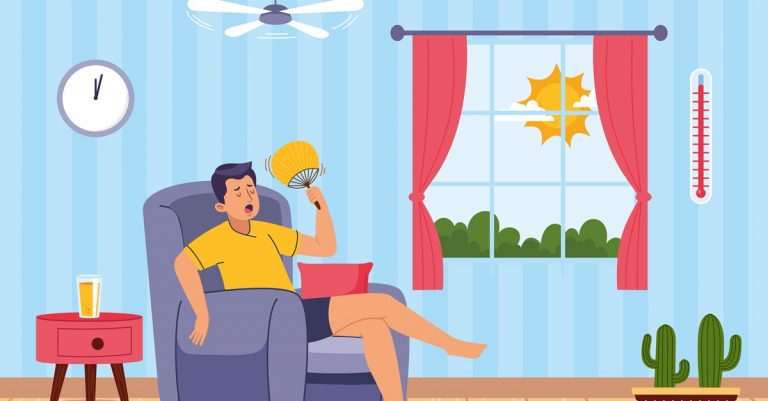 Man sitting in chair fanning himself during hot weather at home, showing heatwave, high temperature and discomfort indoors