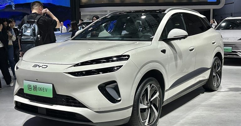 BYD Sealion 06 EV electric SUV displayed at auto show, showcasing modern EV design and automotive innovation