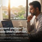 Malaysian investor reviewing a trading platform late at night — iMoney guide to BNM's Financial Consumer Alert list update